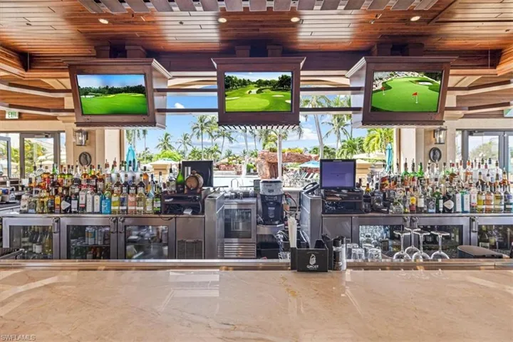 Indoor wet bar featuring wooden ceiling and healthy amount of natural light