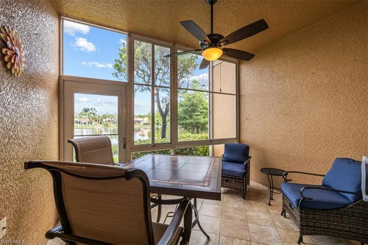 Sunroom with a ceiling fan, healthy amount of natural light, and outdoor dining space