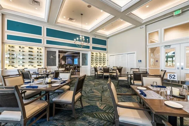 Community lobby featuring coffered ceiling, beamed ceiling, ornamental molding, and a high ceiling