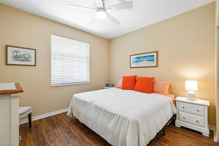 Bedroom featuring dark wood-type flooring and ceiling fan