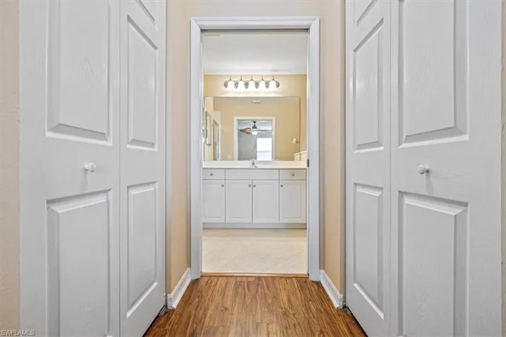 Hall featuring light wood-style flooring and baseboards