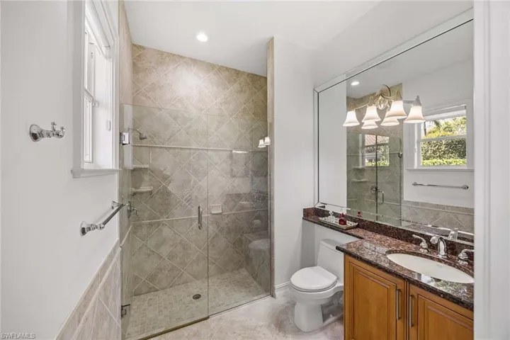 Full bath with vanity, a shower stall, and recessed lighting