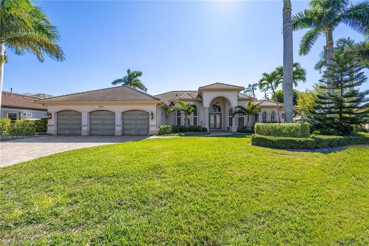 Mediterranean / spanish house featuring a front lawn, stucco siding, decorative driveway, a garage, and a tile roof