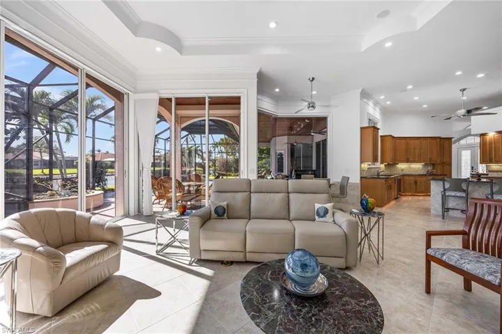 Living area featuring a ceiling fan, ornamental molding, a sunroom, and recessed lighting