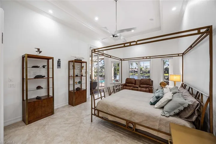 Bedroom with ornamental molding and recessed lighting