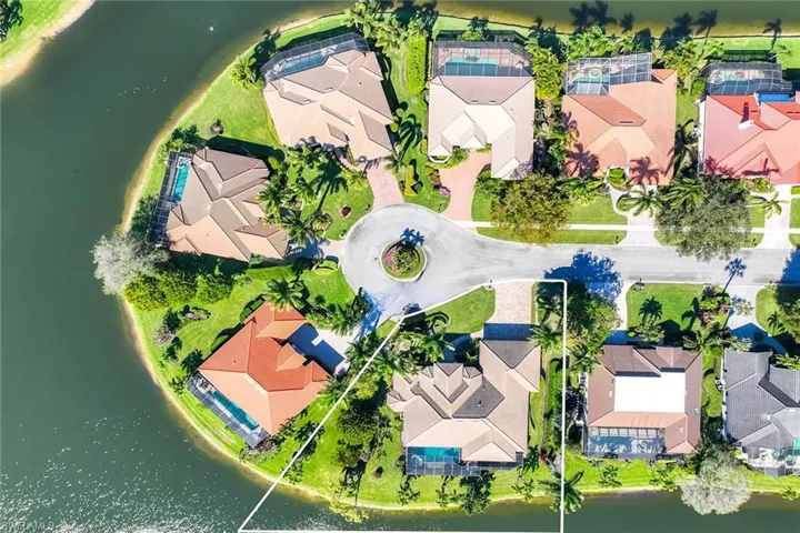 Aerial view of residential area featuring a large body of water