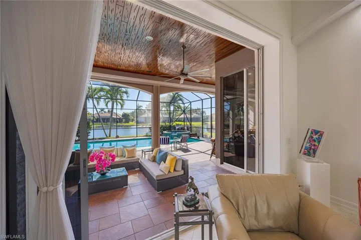 Sunroom / solarium with an outdoor living space, ceiling fan, a patio, and a water view