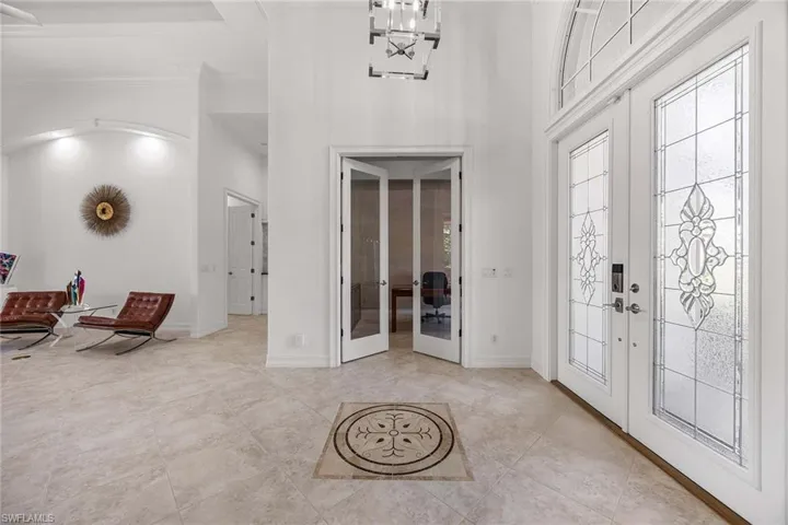 Foyer featuring french doors and a high ceiling