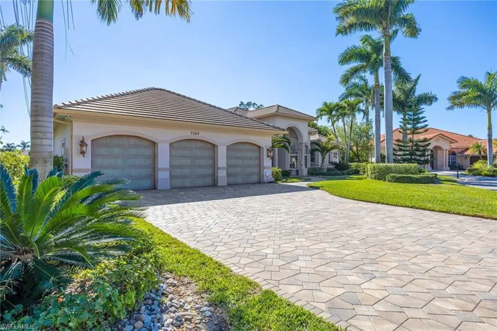 Mediterranean / spanish house with decorative driveway, stucco siding, a garage, a tiled roof, and a front yard