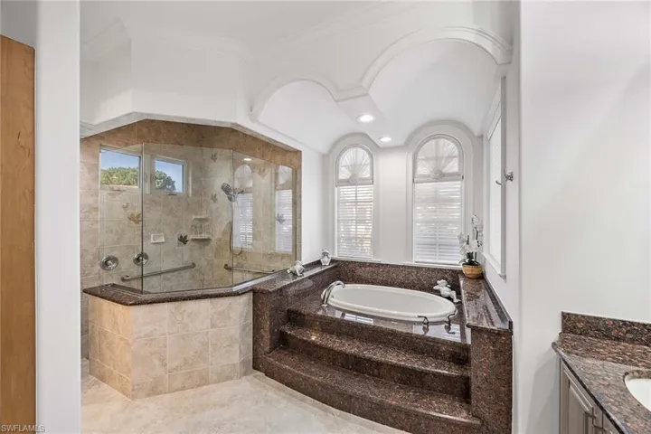 Full bath featuring walk in shower, a bath, and vanity