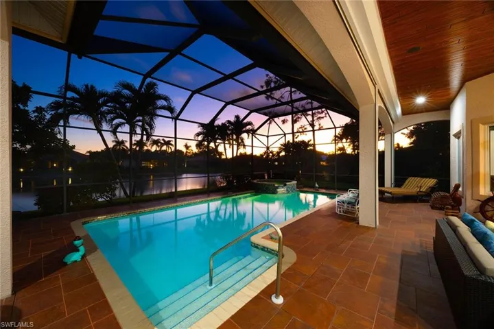 View of pool with a patio, a lanai, a sunroom, and a pool with connected hot tub