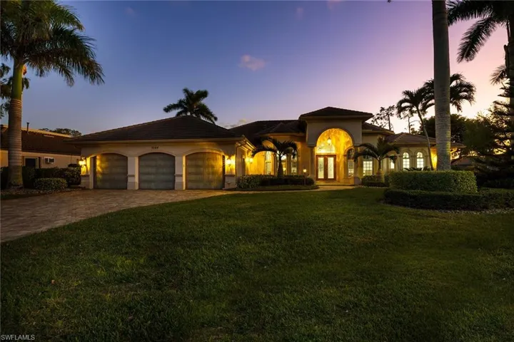 Custom Built home featuring decorative driveway, a yard, a garage, stucco siding, and a new tile roof