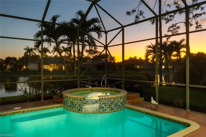 View of pool featuring a lanai, a sunroom, and a pool with connected hot tub
