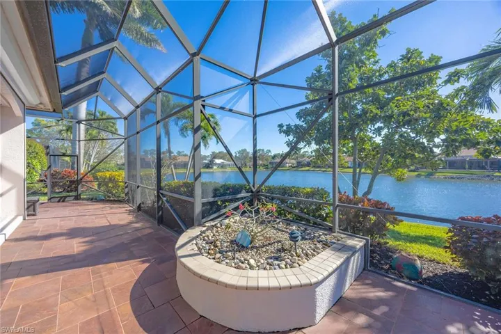 View of patio / terrace featuring a sunroom, a lanai, and a water view