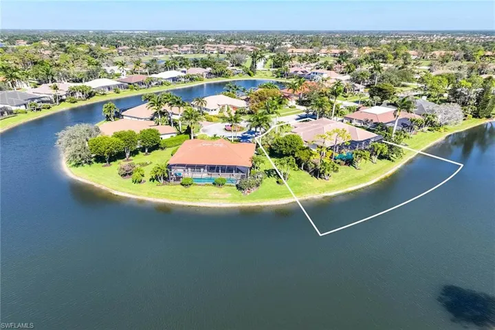 Aerial view of residential area featuring a large body of water