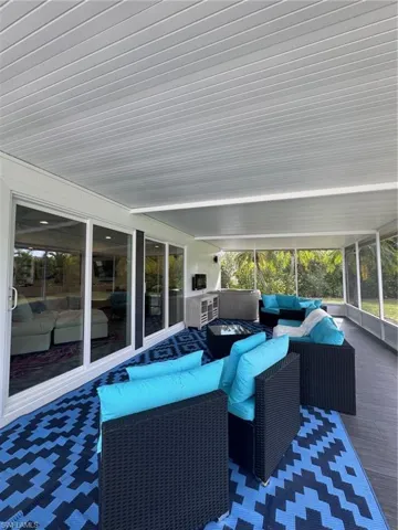 Sunroom featuring an outdoor living space