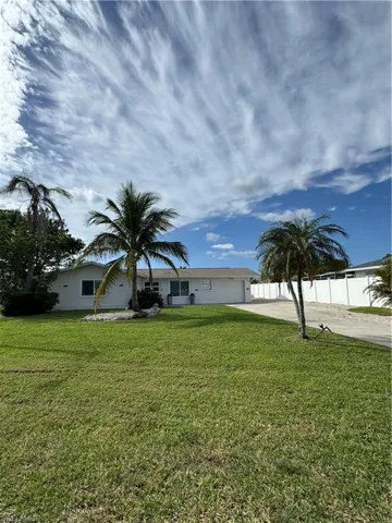 Ranch-style house with concrete driveway