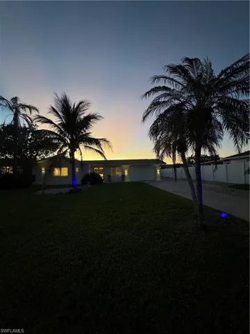 View of yard featuring concrete driveway