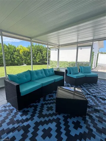 View of patio / terrace featuring a sunroom and an outdoor living space