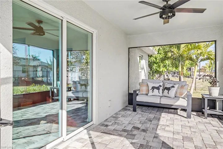 Sunroom featuring a ceiling fan, a patio, outdoor furniture, and plenty of natural light