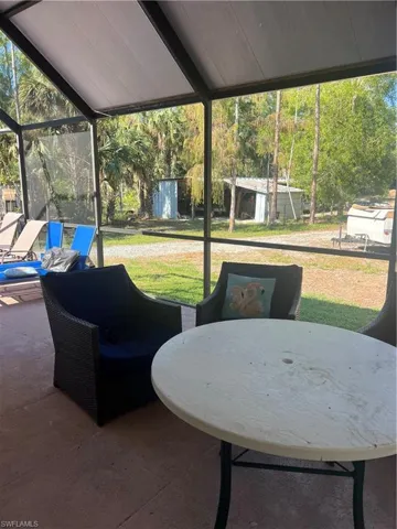View of patio / terrace featuring a sunroom and a shed
