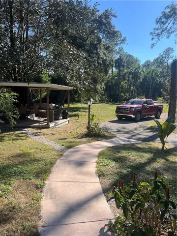 View of grassy yard featuring a patio area