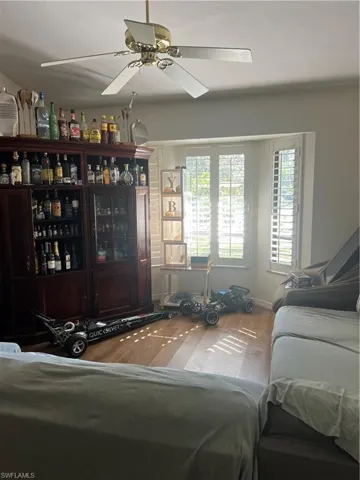 Living room with wood finished floors and ceiling fan