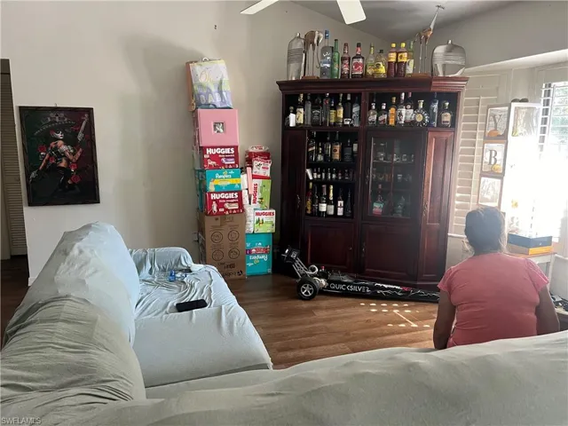 Living area with wood finished floors and ceiling fan