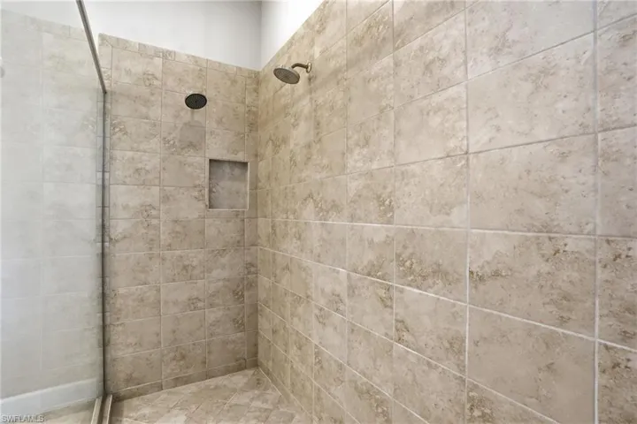 Full bath featuring tiled shower