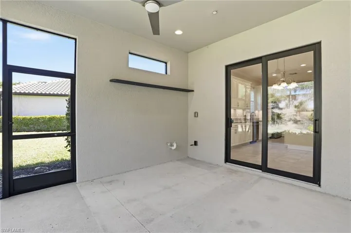 View of patio / terrace with a ceiling fan and a sunroom