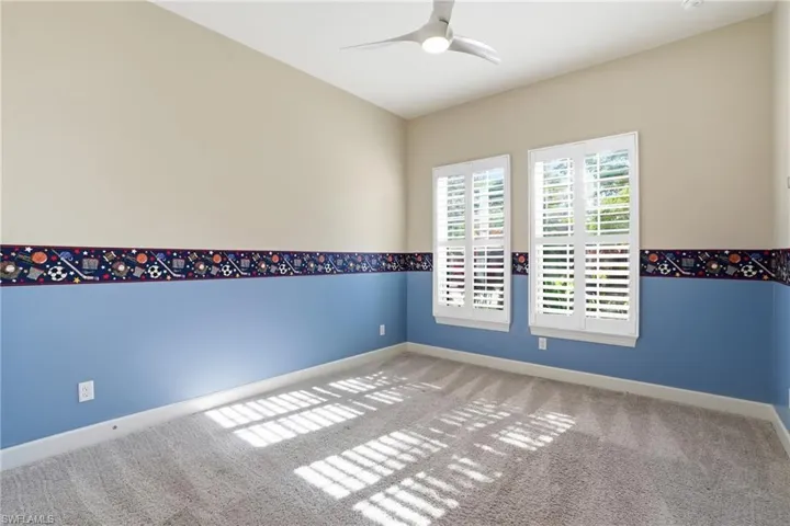 Unfurnished room featuring ceiling fan and carpet floors