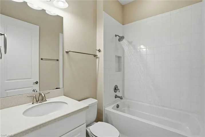 Bathroom with vanity and bathtub / shower combination