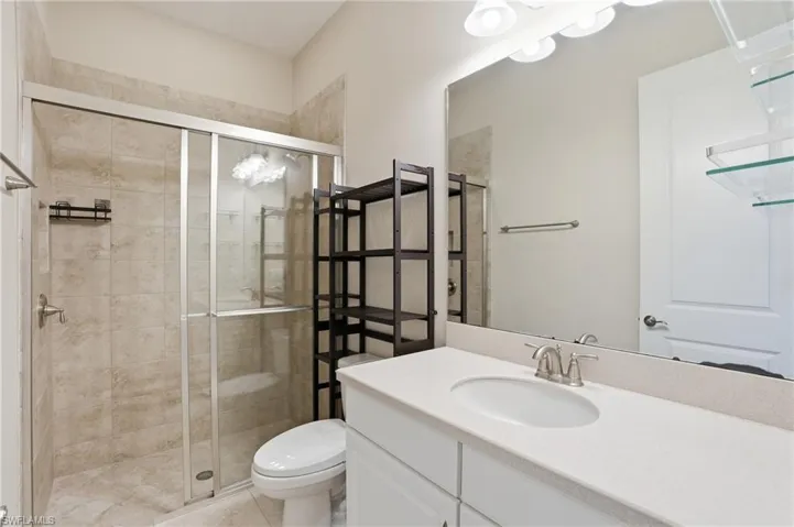 Full bath with vanity and a stall shower