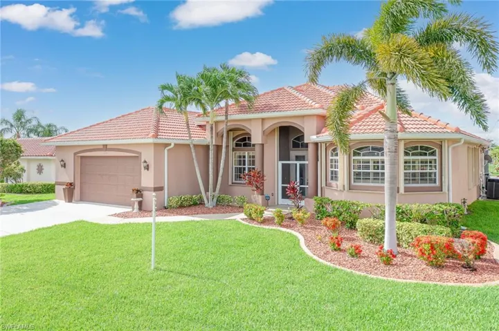 Mediterranean / spanish-style home with a front yard, a garage, and central air condition unit