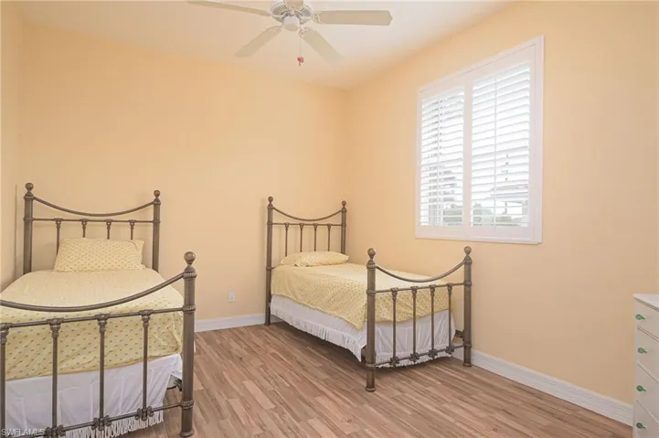 Bedroom featuring ceiling fan and light hardwood / wood-style flooring