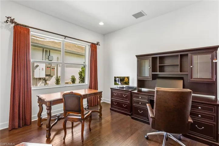 Home office featuring dark wood finished floors and recessed lighting