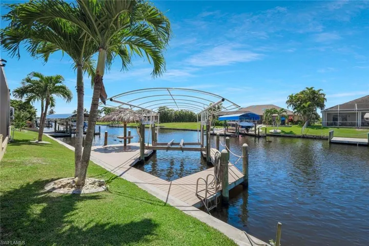 Dock with a yard, a water view, and boat lift