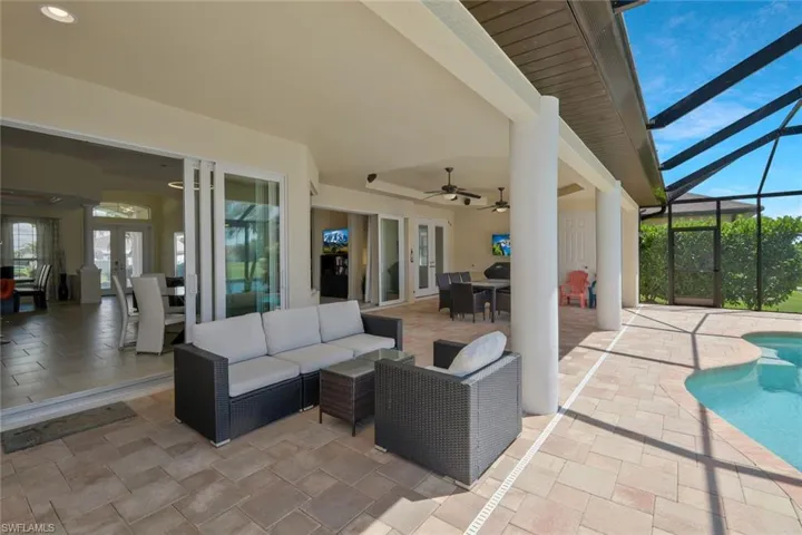 View of patio / terrace featuring a sunroom, outdoor dining space, an outdoor living space, and french doors