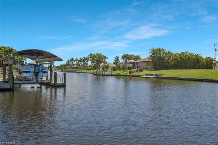 Dock area with a water view and boat lift
