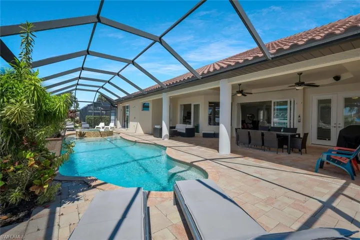 View of swimming pool with an outdoor hangout area, a sunroom, a patio, and glass enclosure