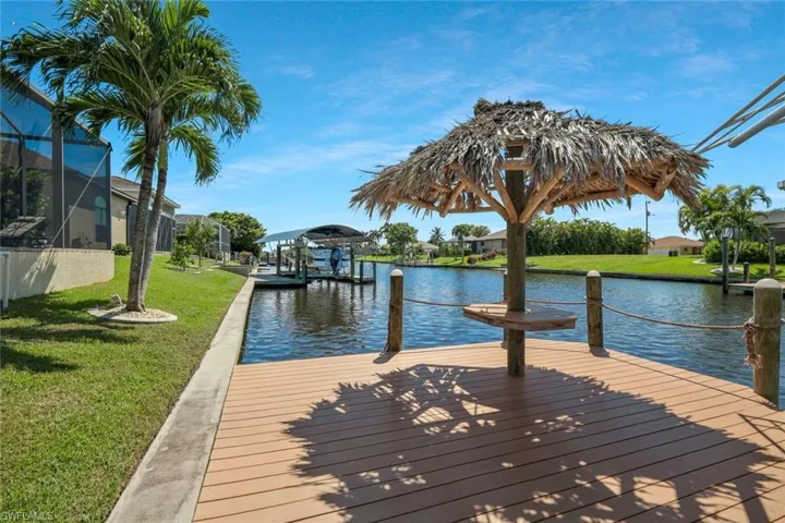 Dock area featuring a lawn and a water view