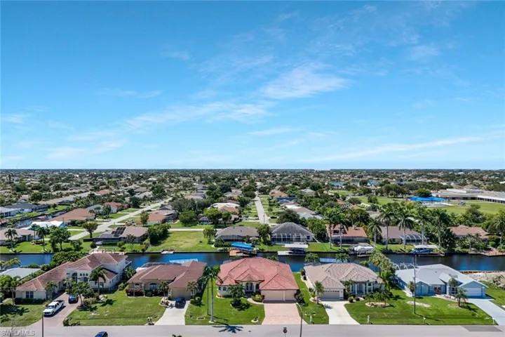 Aerial perspective of suburban area featuring a large body of water