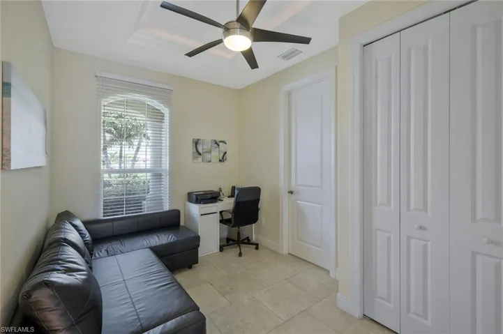 Home office with a ceiling fan and baseboards