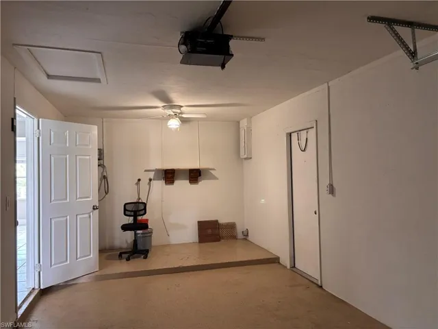 The garage features a ceiling fan, a garage door opener, and an access panel in the ceiling