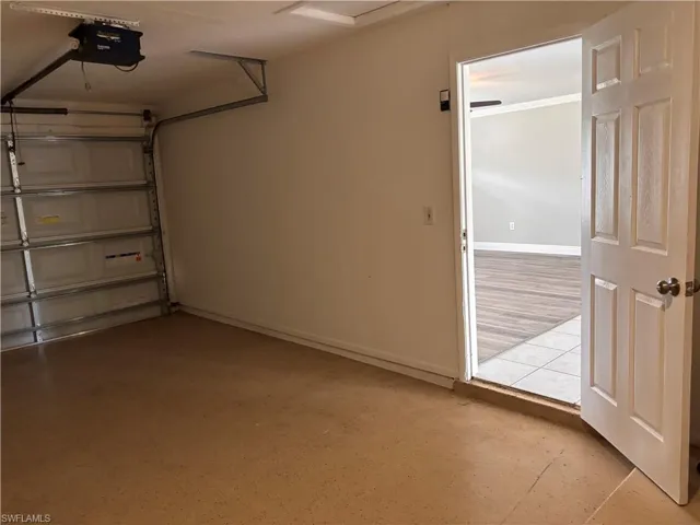 The property includes a garage with a roll-up garage door and an automatic garage door opener