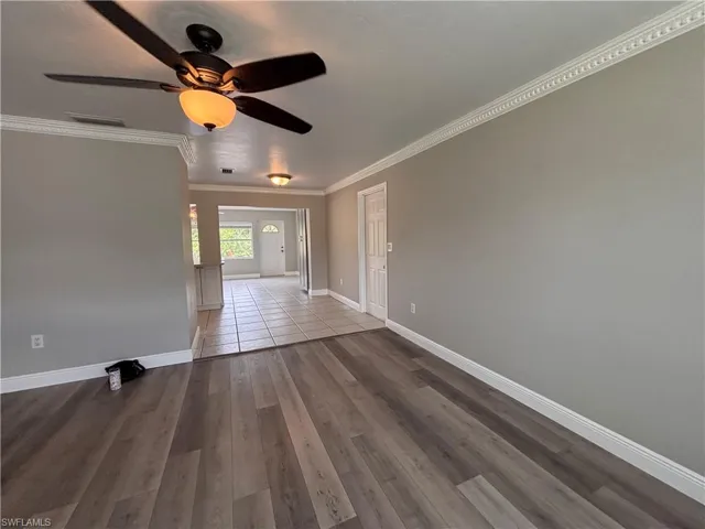 Living space with wood-look flooring and light grey walls