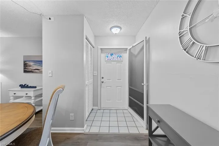 Entrance foyer featuring a textured ceiling and light wood-type flooring