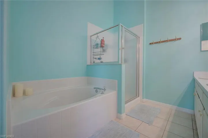 Clean and bright primary bathroom with soaking tub and walk in shower.