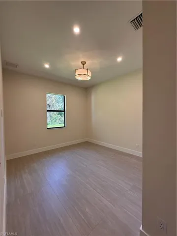 Spare room featuring recessed lighting and baseboards