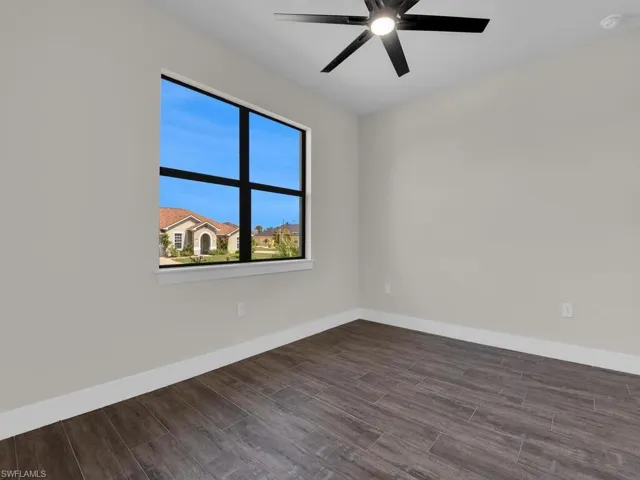 Spare room with wood tiled floors and ceiling fan